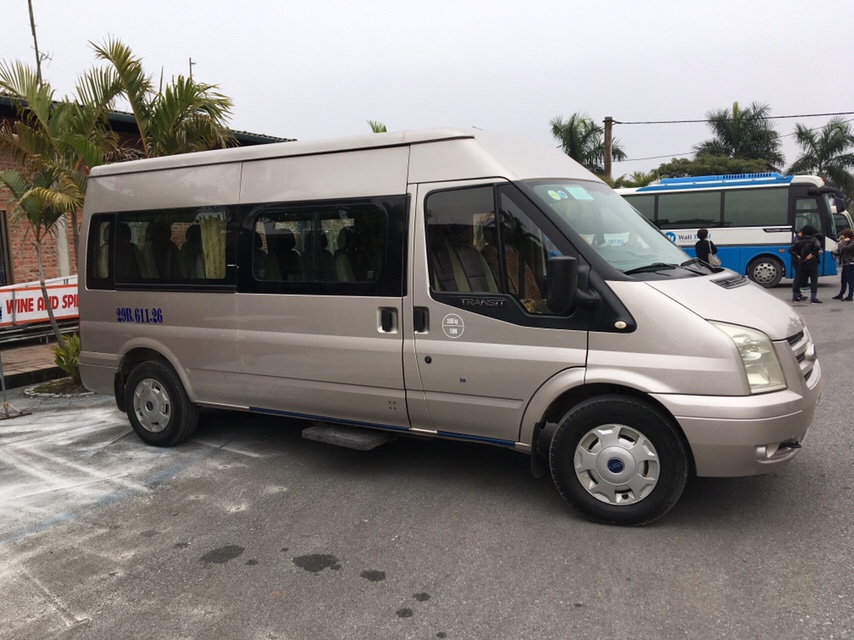 Tour van picking up travelers in Hanoi on a cloudy morning
