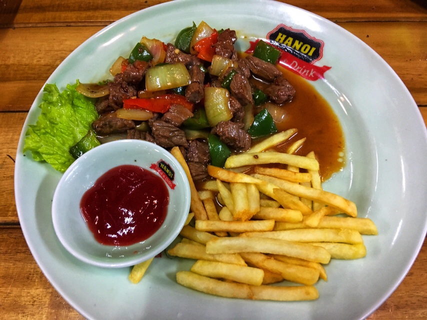 Vietnamese dish Bò Lúc Lắc on a restaurant table in Hanoi