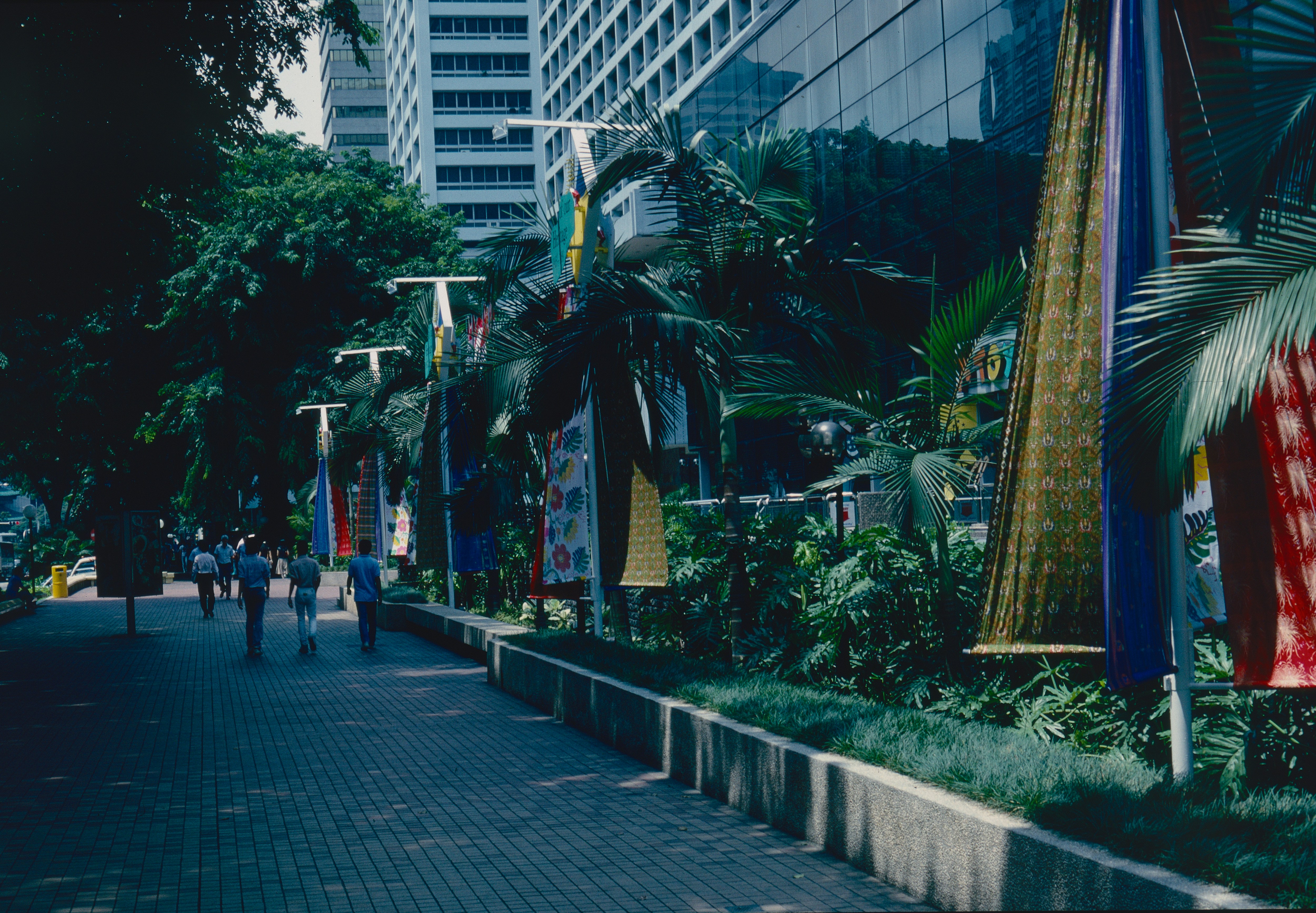 Wide, paved sidewalk in Singapore, showing the city's pedestrian-friendly and accessible walkways.